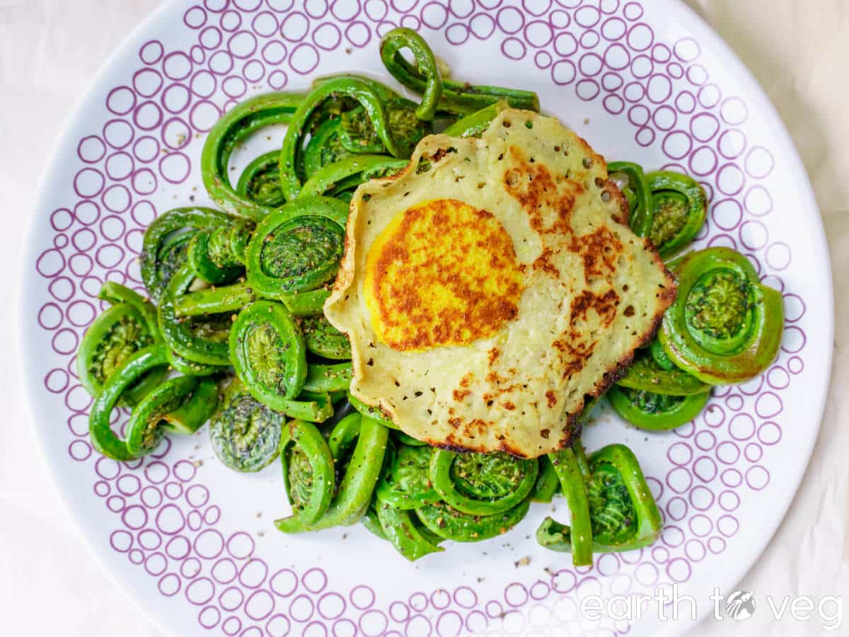 Sauteed fiddleheads with vegan tofu egg.