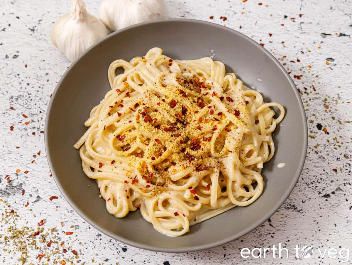 A bowl of linguine pasta tossed in dairy free soy milk alfredo sauce.